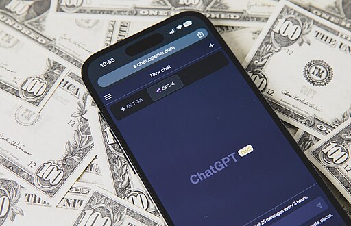 Smartphone with ChatGPT on the US dollar banknotes background